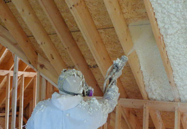 Open-cell spray foam insulation between attic rafters