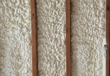 Closed-cell spray foam filling a wall cavity to strengthen the structure