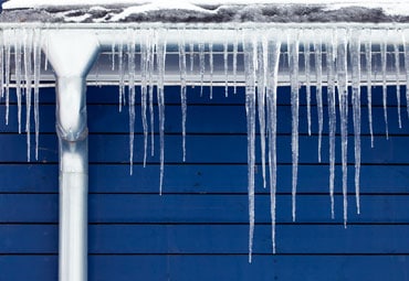 Ice dam forming on a Kansas City roof caused by attic heat loss