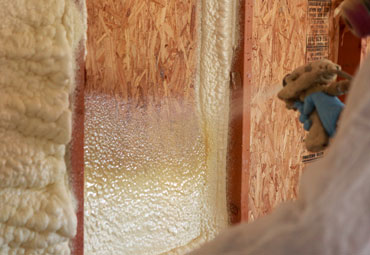 Spray foam insulation being applied to create a continuous air barrier in a Kansas City home's building envelope